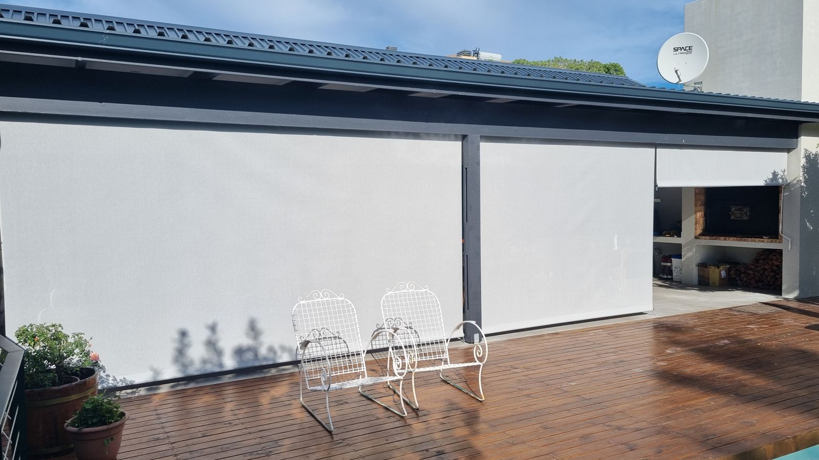 Grey blinds under a dark patio roof