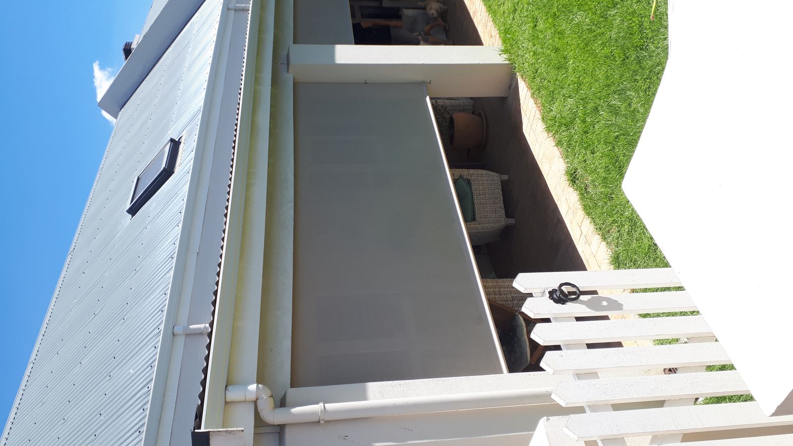 Side-patio blind, rolled down for shade