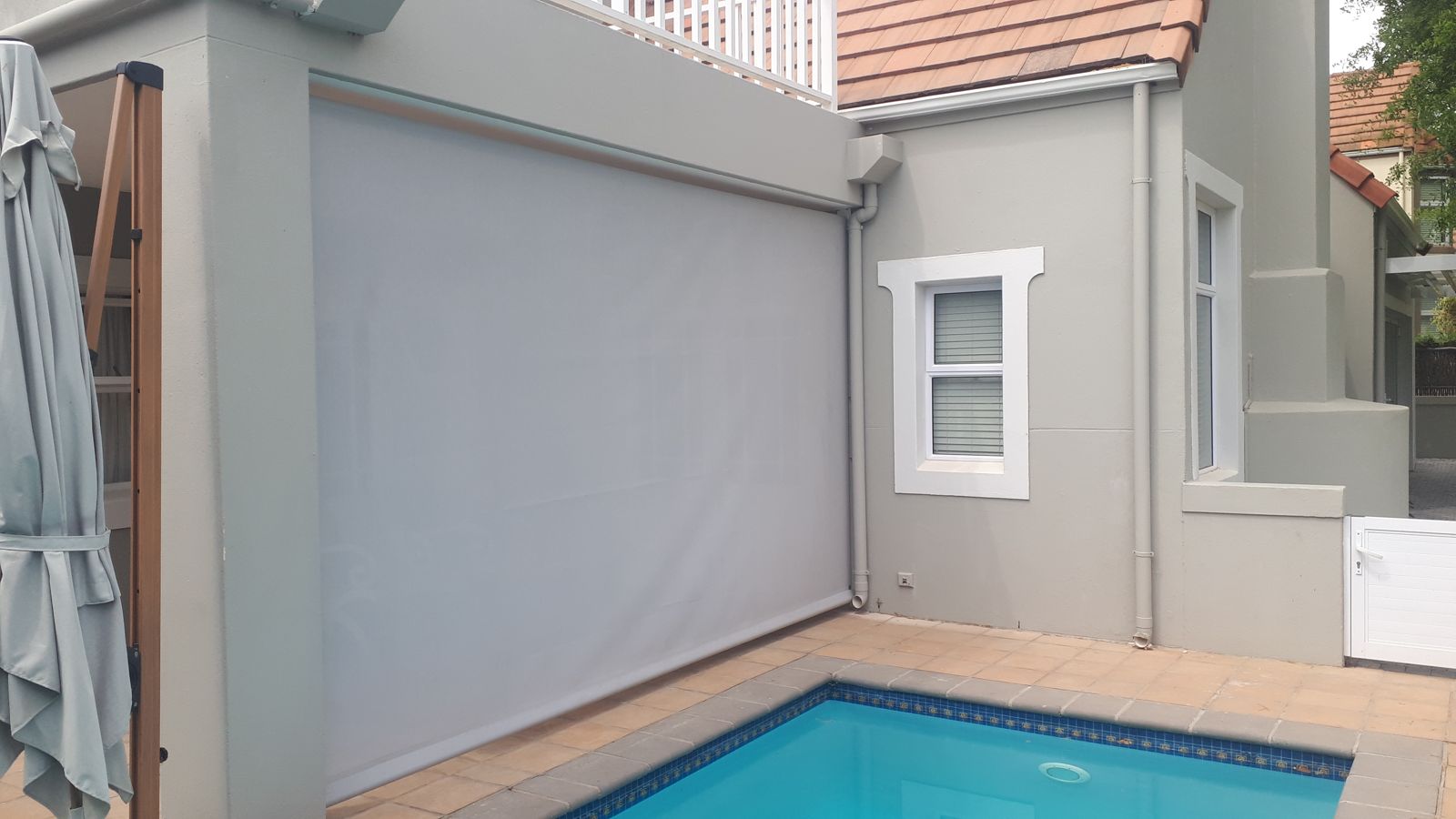 Large drop blind beside the pool