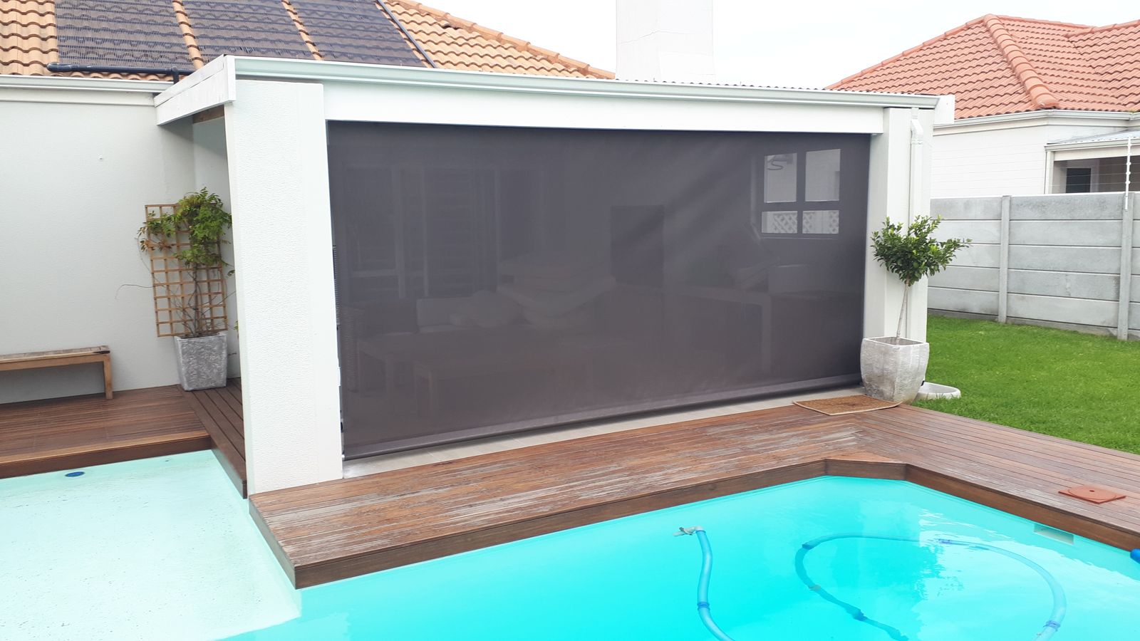 Shade blind closed over a pool patio